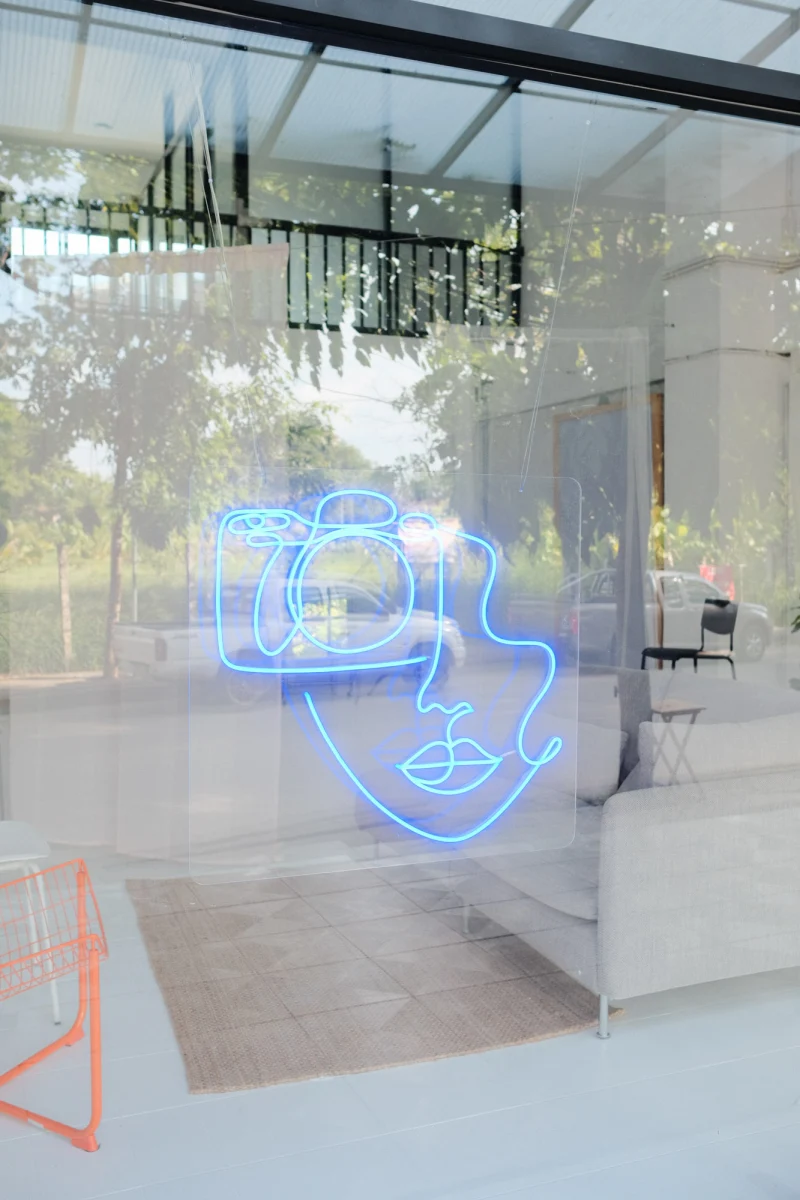 Neon camera sign detail inside our creative production studio in Chiang Mai